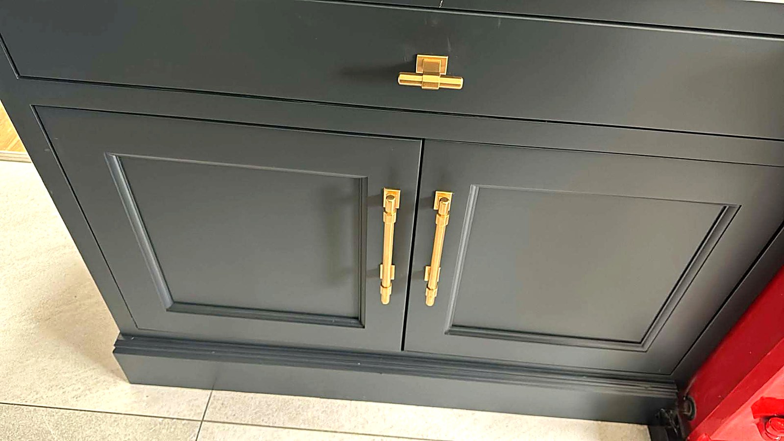 Navy sprayed base units with brass bar handles