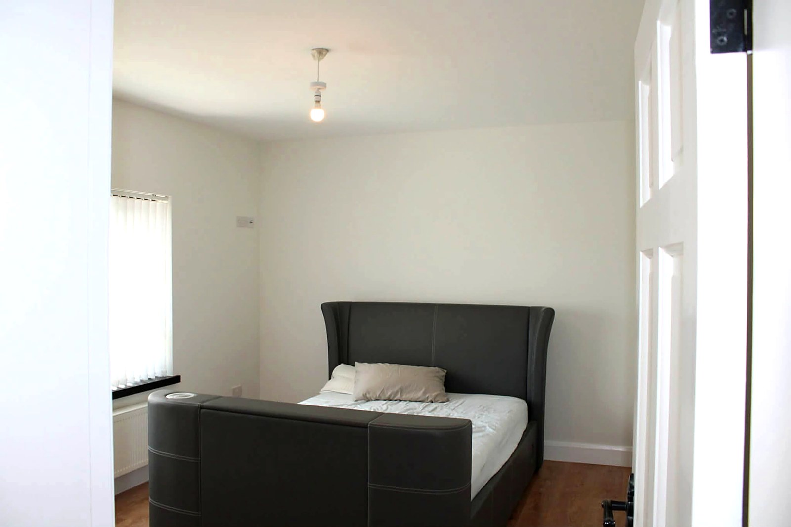 Bedroom finished in a soft white with clean cut-in around the ceiling