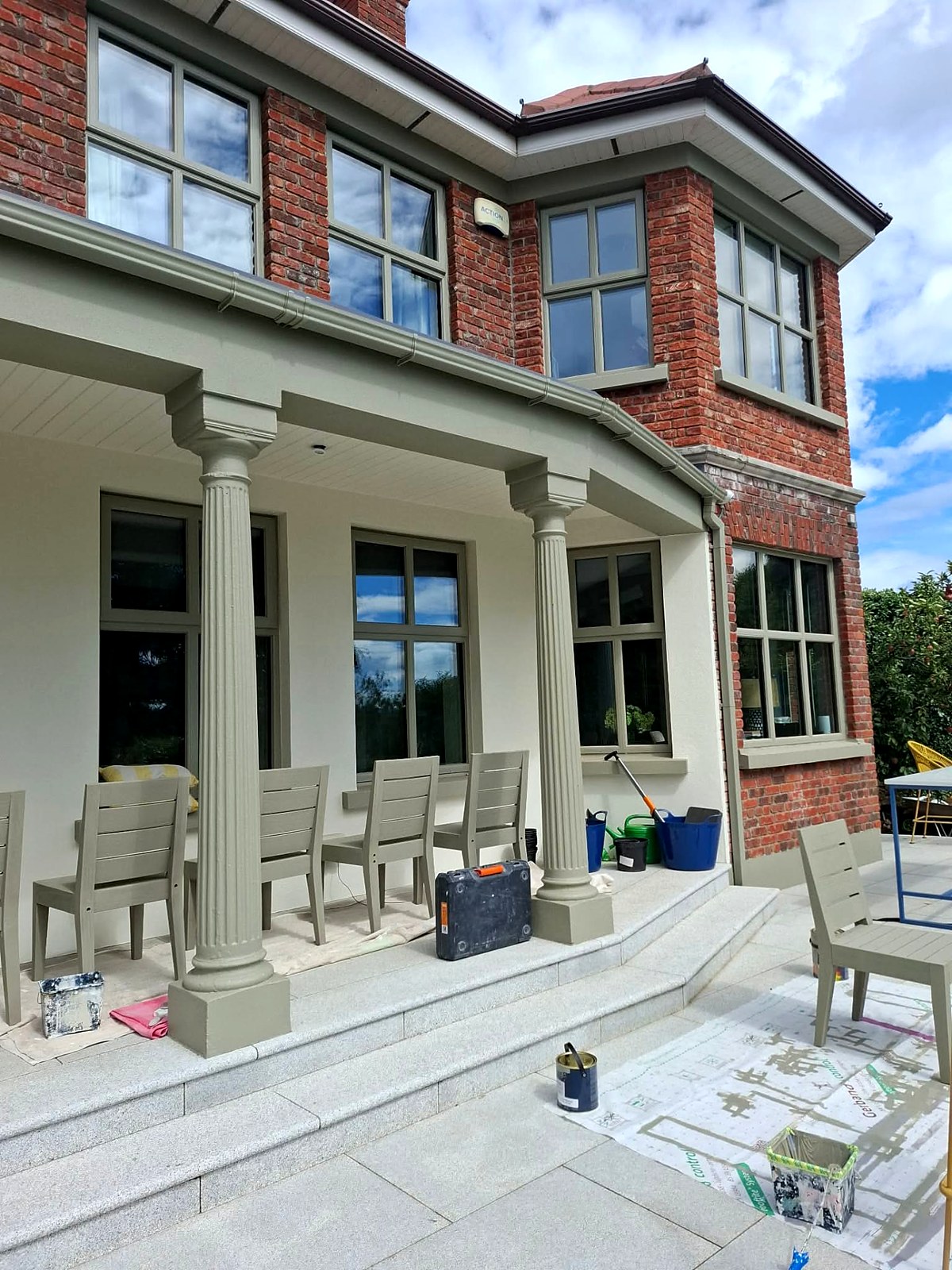 Painted porch columns, soffit and window frames in a soft sage green