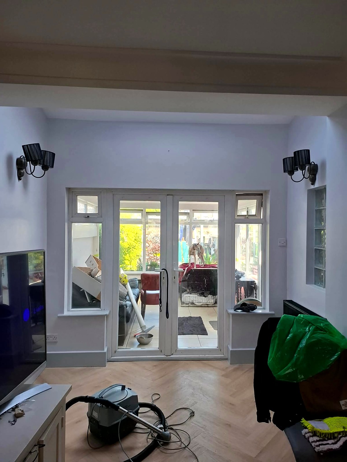 Sitting room repainted around French doors with fresh white woodwork