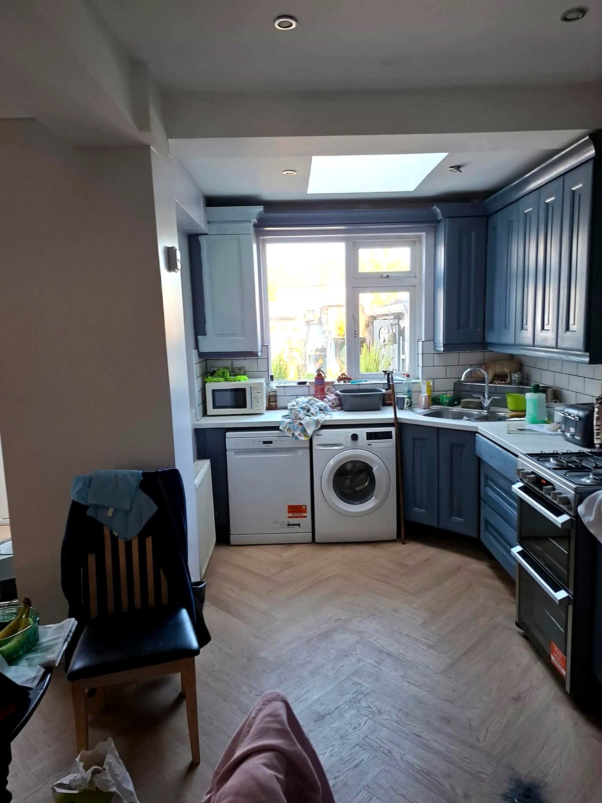 Dated blue painted kitchen units before a full re-spray