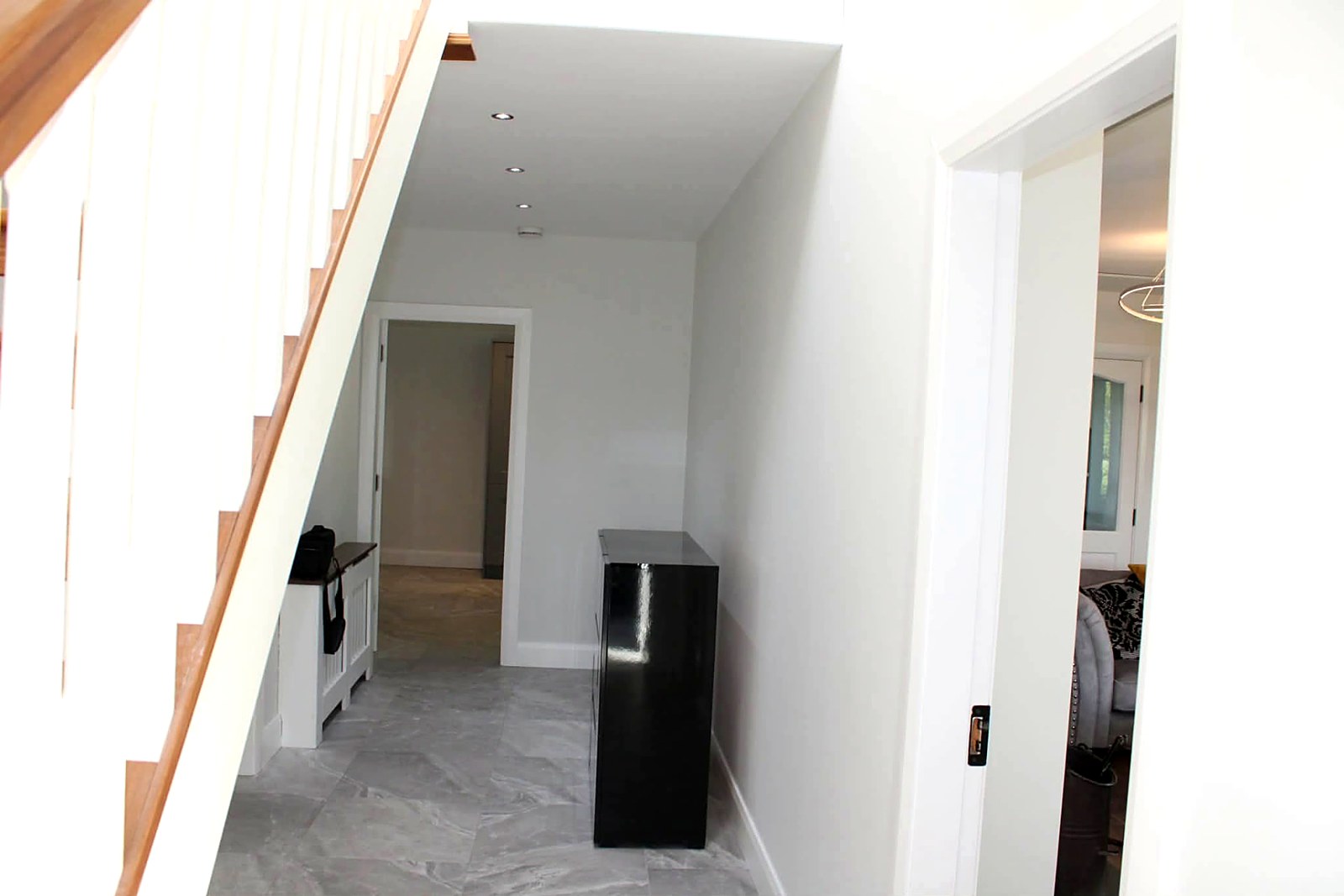 Hallway and under-stairs area painted in a clean modern white