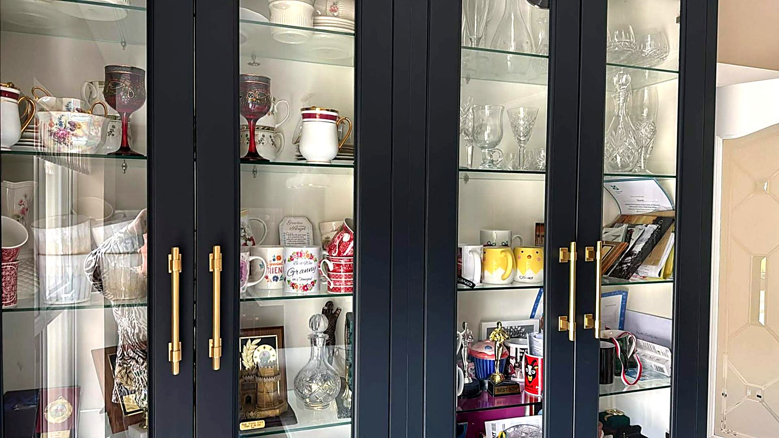 Navy painted glazed display cabinets with brass handles