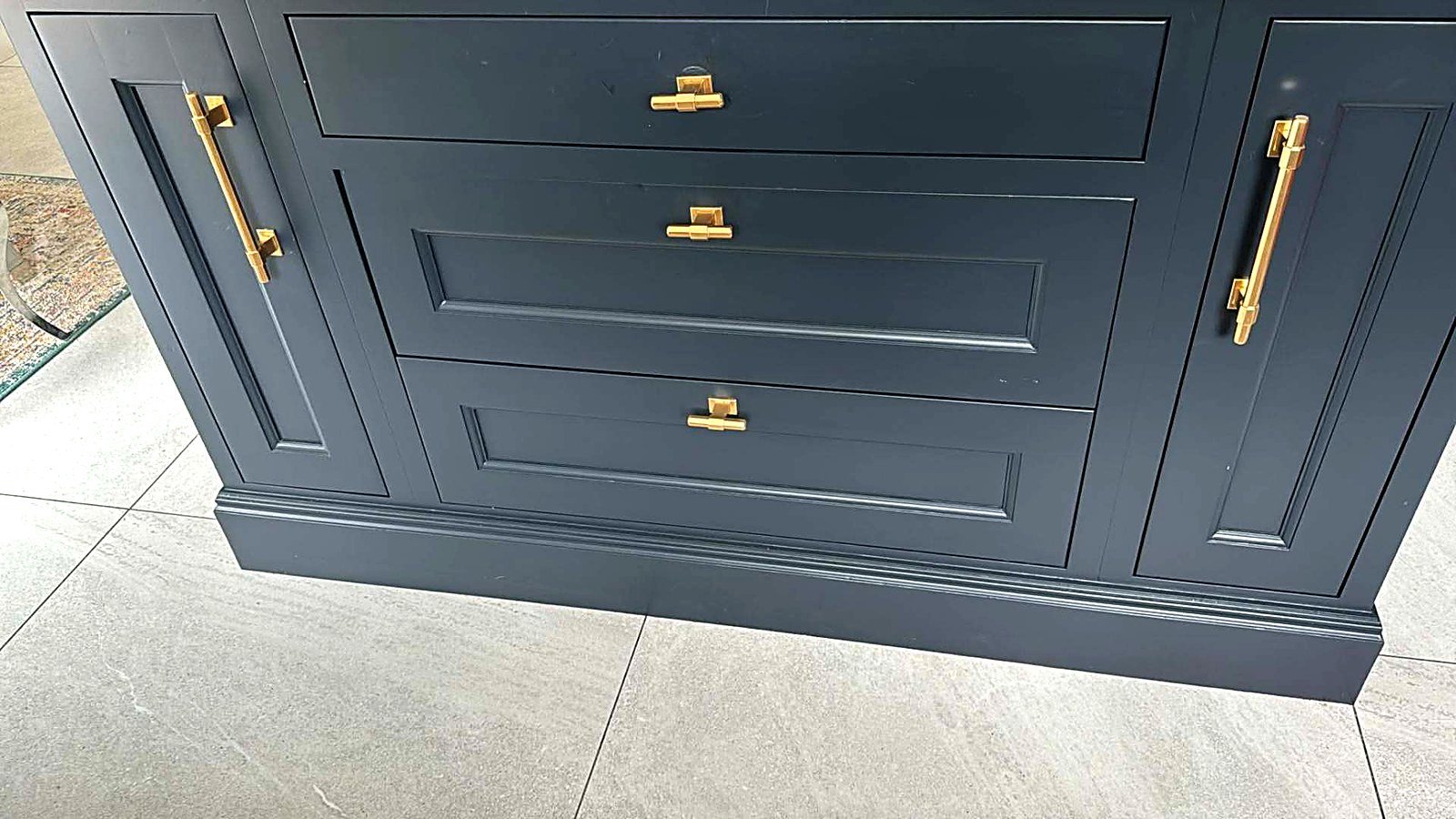 Navy painted drawer bank with brass hardware and moulded plinth