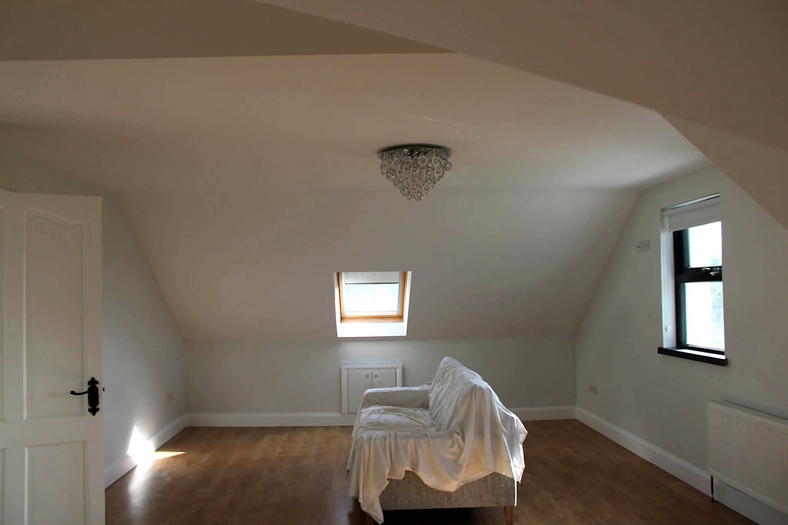 Converted attic bedroom painted throughout in a clean off-white