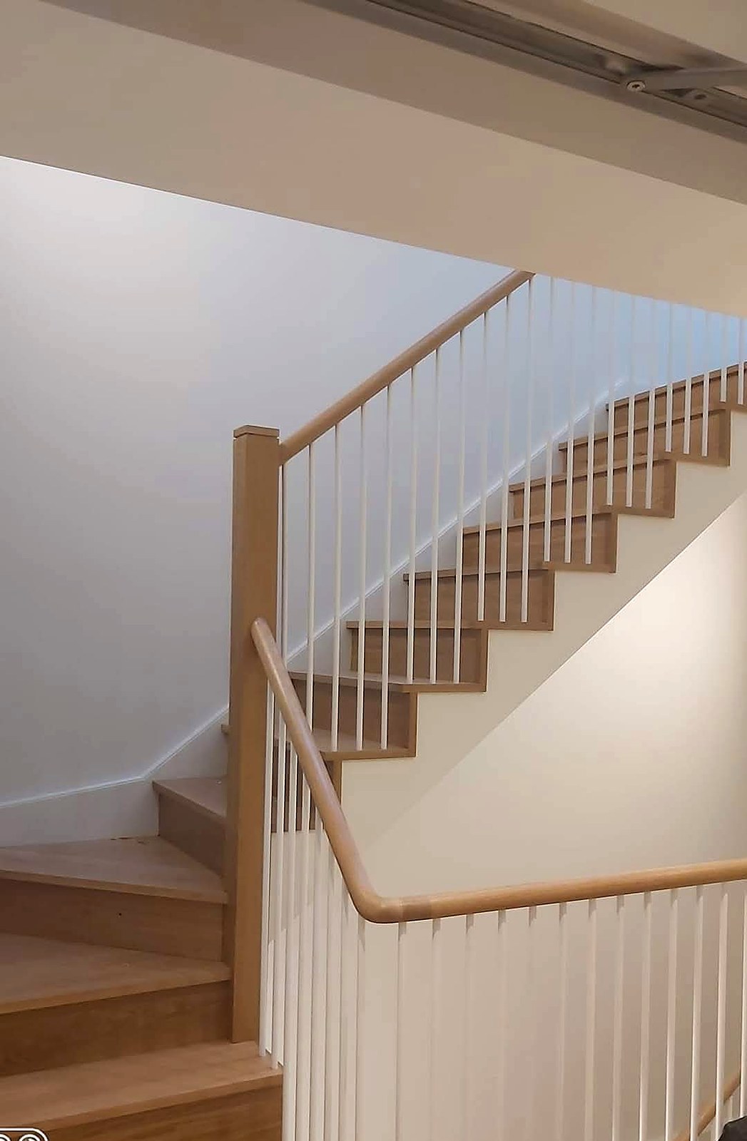 Oak stair treads with hand-painted white spindles and stringers