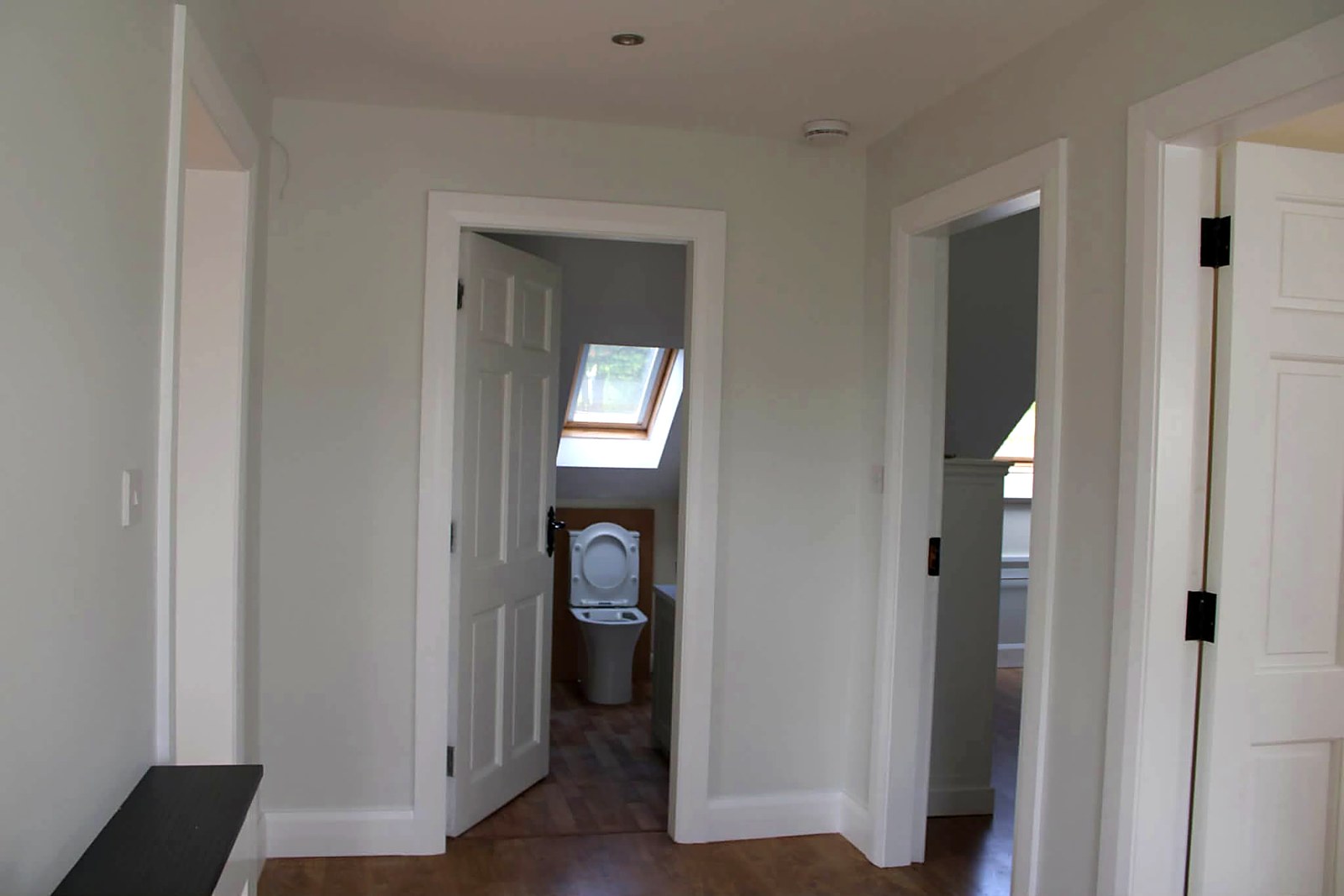Landing with painted doors, architrave and skirting in bright white
