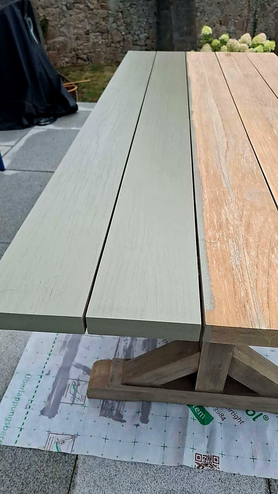 Garden table half sanded and half coated in sage green paint