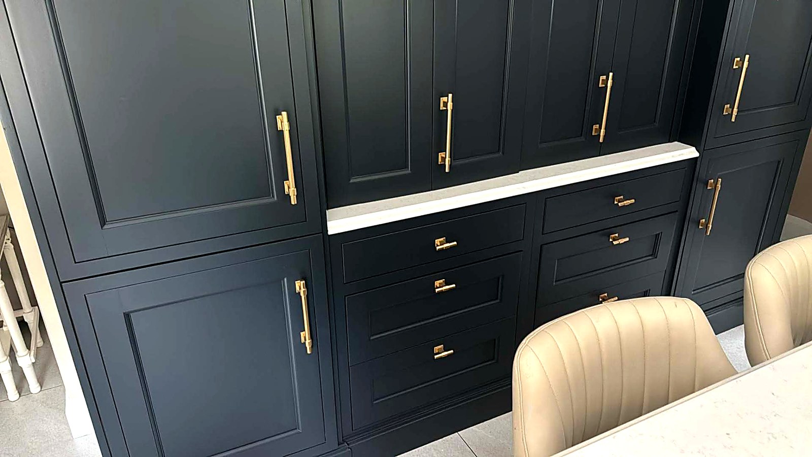 Deep navy hand-painted kitchen dresser with brass handles
