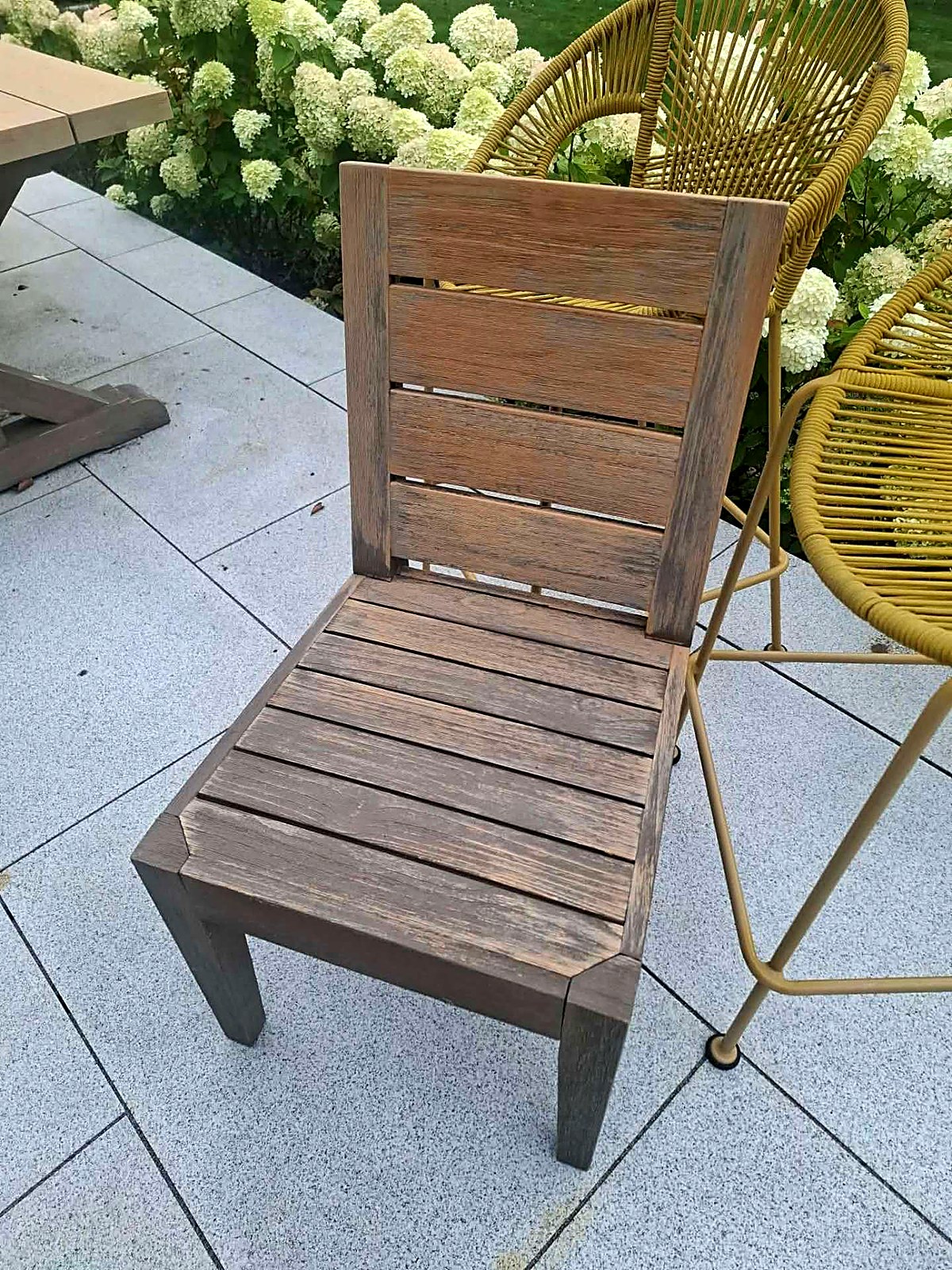 Weathered grey garden chair before restoration
